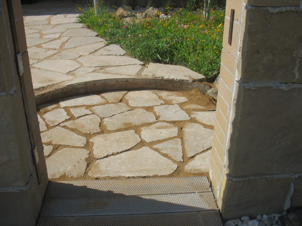 The pieces of recycled concrete had to be broken with a sledgehammer, then reassembled to give a flagstone appearance. PHOTO: River Ridge Landscape Co.